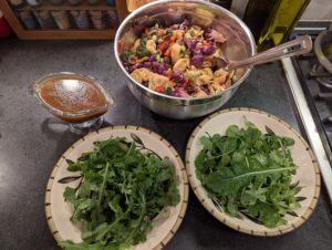 Roasted veggie tortellini salad with edamame served over arugula with a balsamic vinaigrette dressing